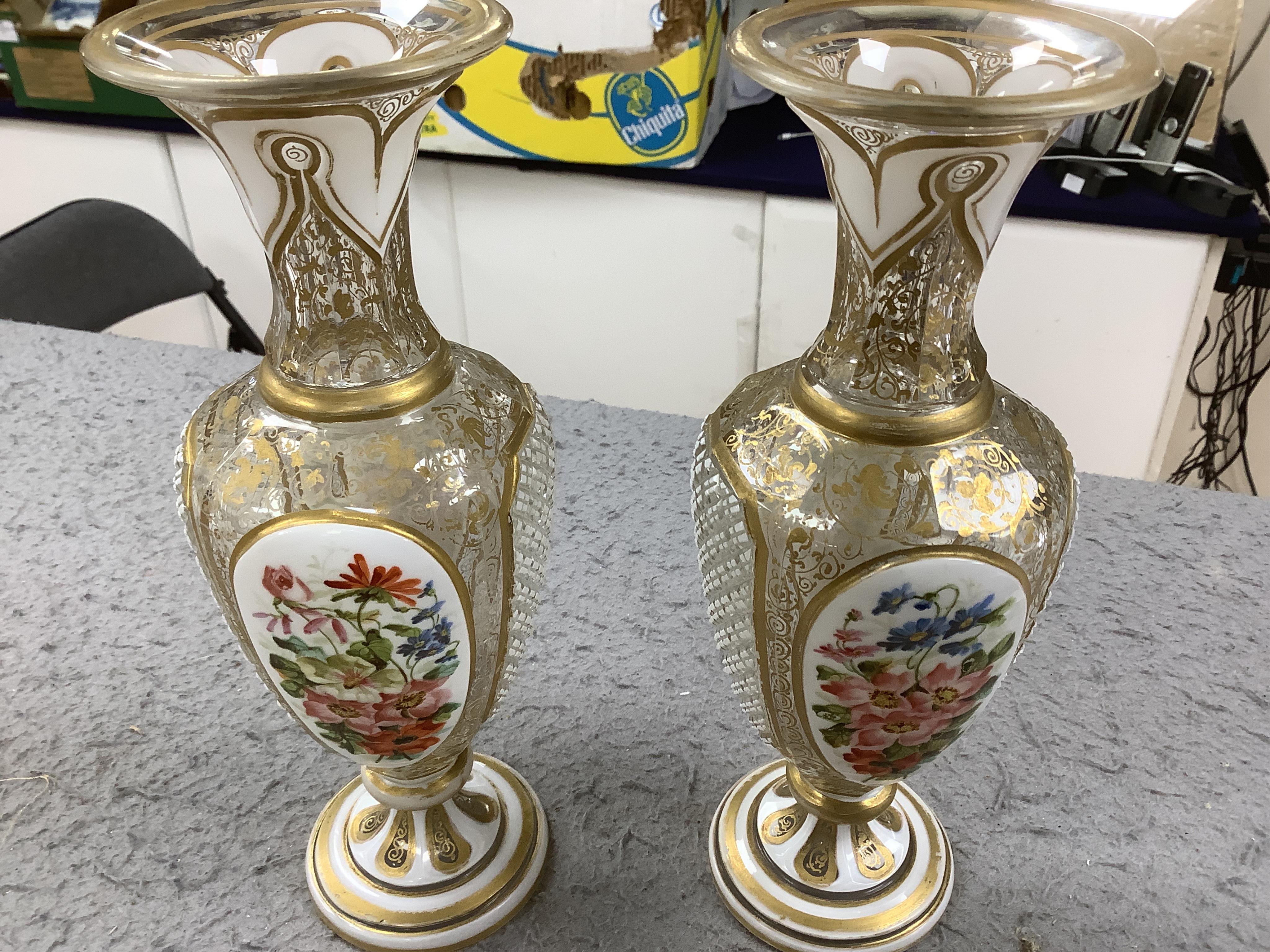 A pair of late 19th century Bohemian enamelled overlaid glass vases, and a similar overlaid glass comport. Condition - vases fair; comport poor